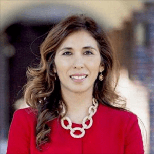 A woman wearing a red jacket and necklace.