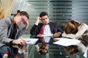 A group of people sitting at a conference table.